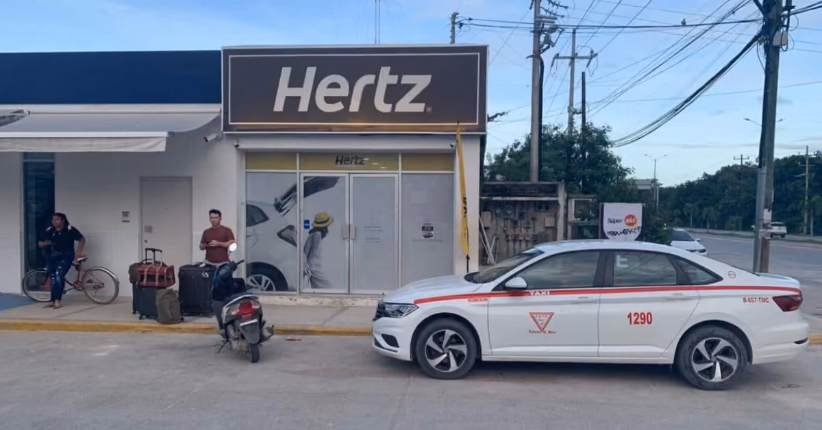 Hertz car rental storefront with glass doors, a taxi and scooter parked outside, and two people: one with luggage, one with a bike.