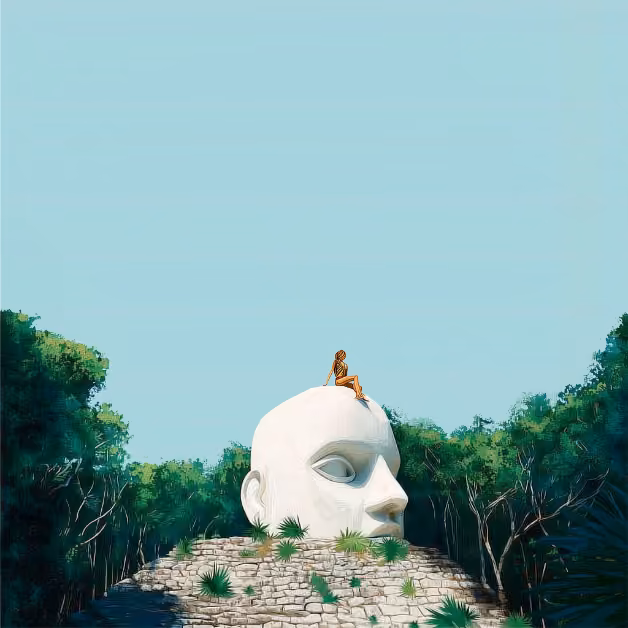 A person sits atop a large white head sculpture amid lush greenery and trees beneath a clear blue sky.