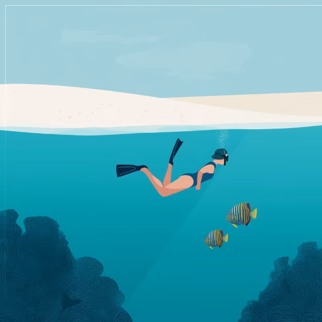 A snorkeler with fins swims near coral and two colorful fish, beneath a sandy beach visible above the clear waterline.