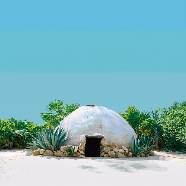 A small adobe hut with a dark entrance sits among green plants and stones beneath a clear blue sky, radiating tranquil beauty.