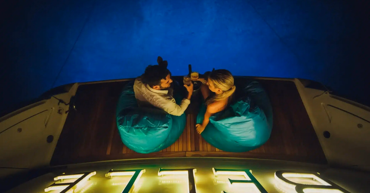 couple toasting during sunset on a boat near tulum