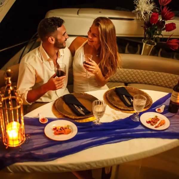 couple enjoying dinner on a yacht near tulum