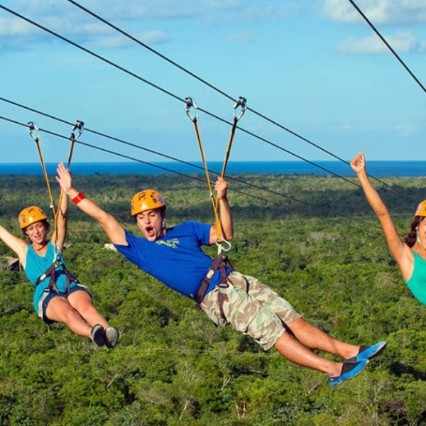 group going down a zipline at xplor