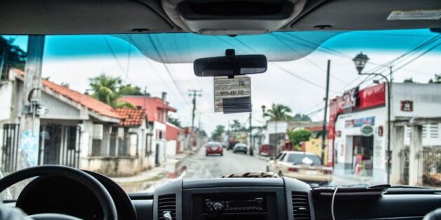 Looking through the wind shield of someone who is driving through Tulum