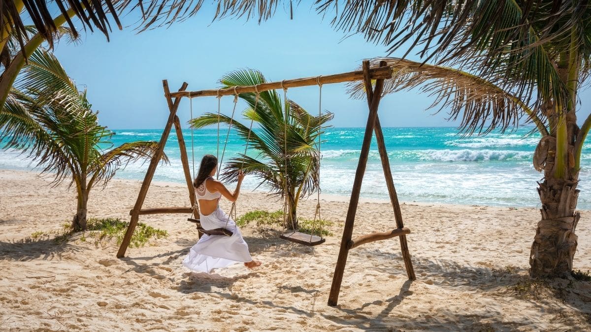 a female solo traveler on the beach in tulum