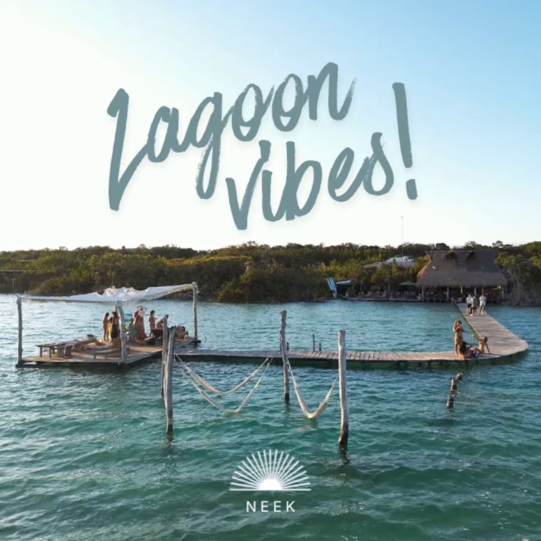 People relax and walk on a pier over a turquoise lagoon, thatched huts behind. “Lagoon Vibes” and sun logo with NEEK included.