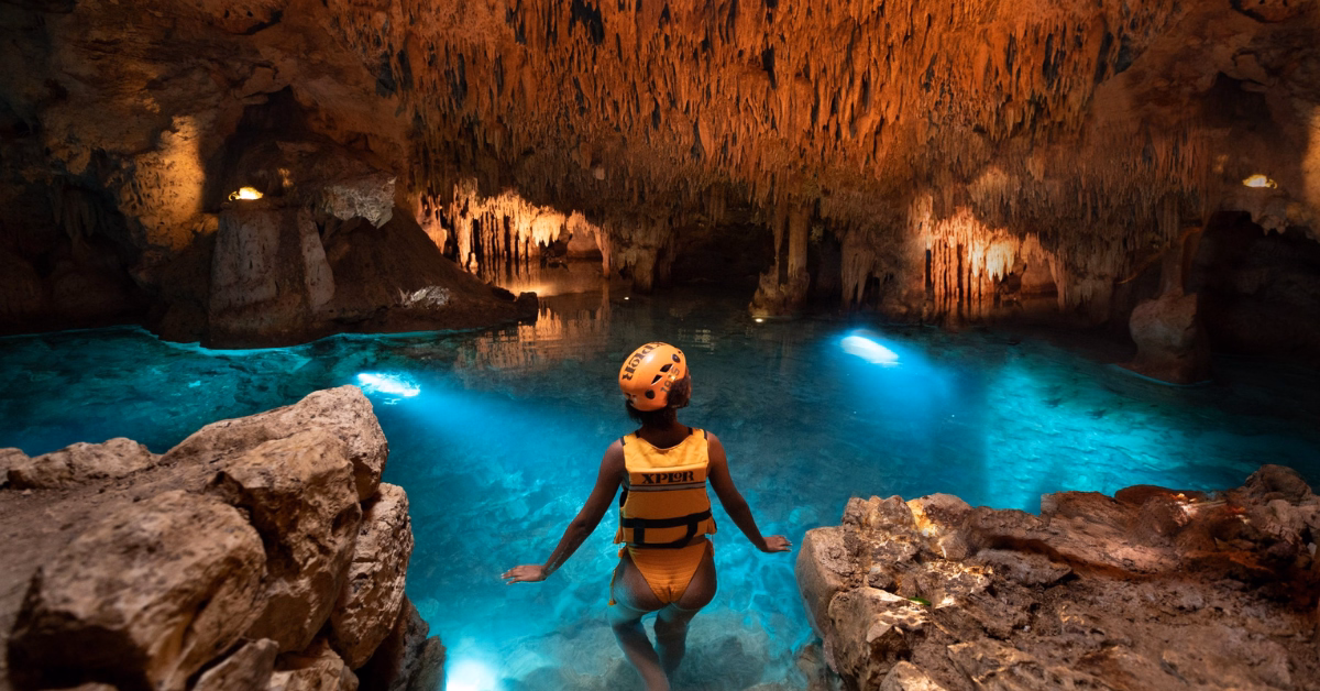 lady going in a cenote at xplor